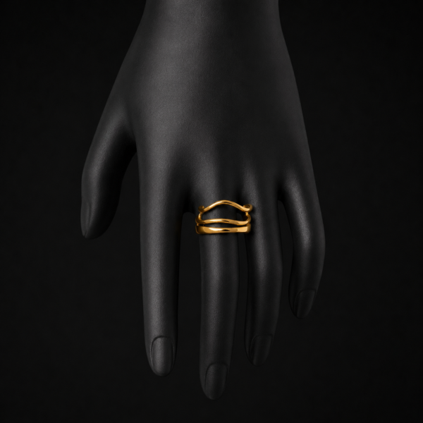 Gold wave ring on black mannequin hand side angle