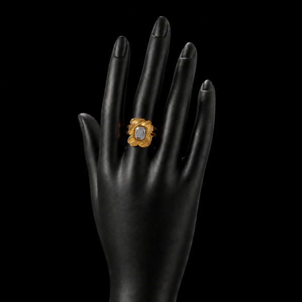Gold square stone statement ring on upright black hand