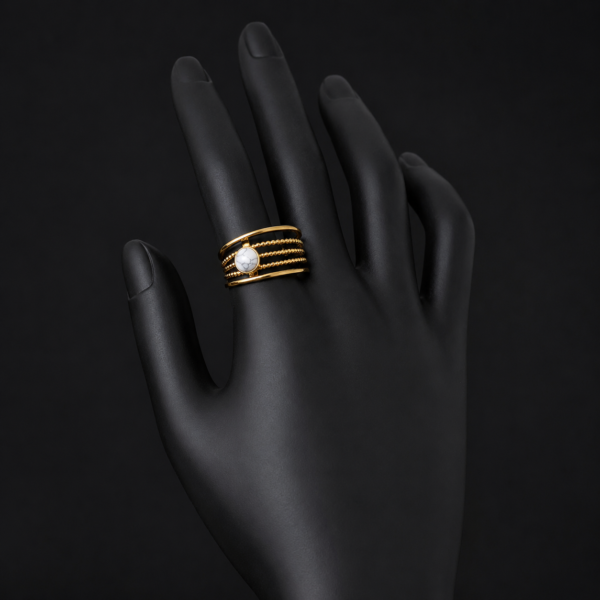 Gold white stone layered ring on upright black hand