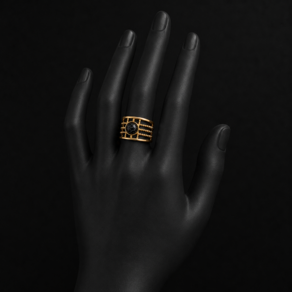 Gold black stone layered ring on upright black hand