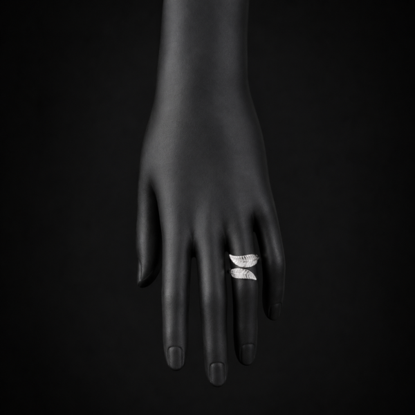 Silver double wing open ring on downward black hand display