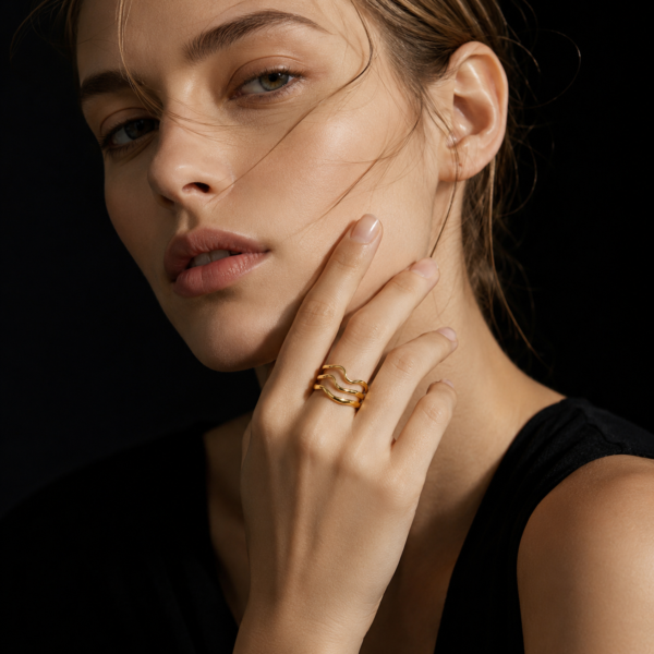 Luxury gold wave ring on female model with black background