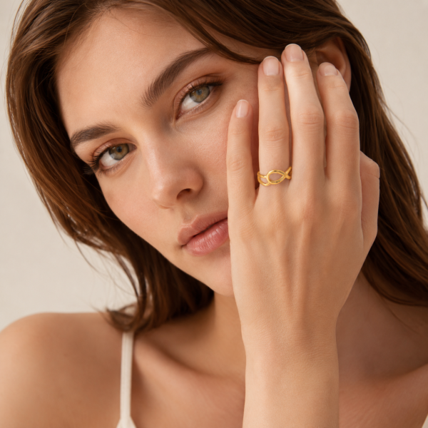 Female model wearing gold infinity ring