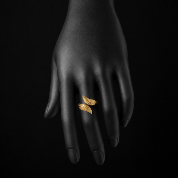 Gold double wing open ring on downward black hand display