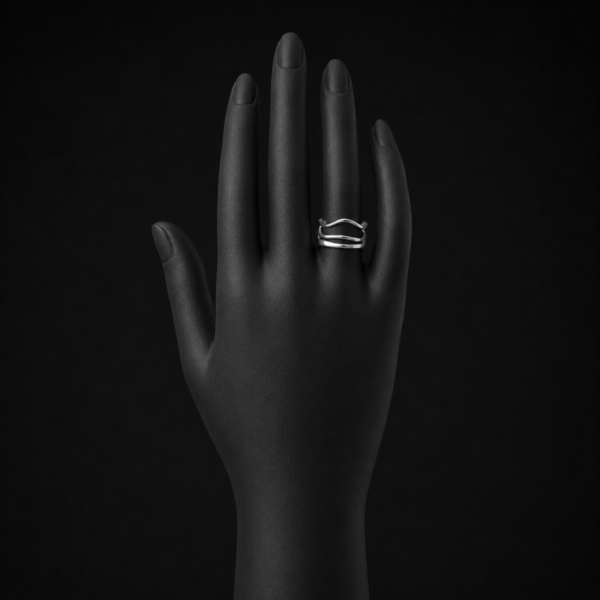 Silver wave ring on black mannequin hand front view