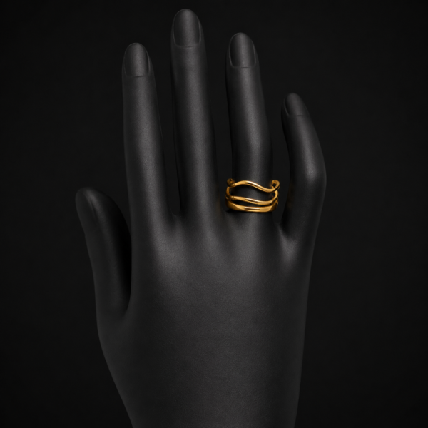 Gold wave ring on black mannequin hand front view