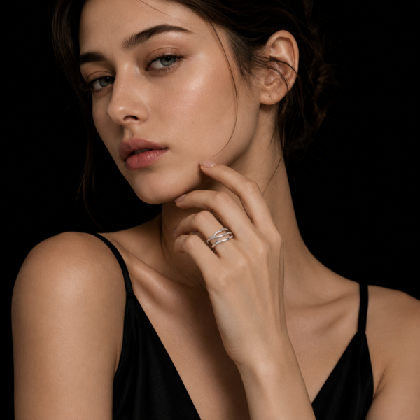 Luxury silver wave ring on female model with black background
