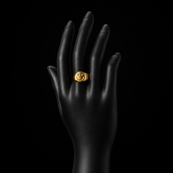 Gold smiley face signet ring on upright black hand mannequin