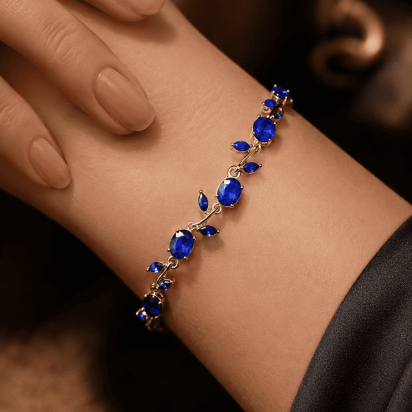 Close-up of a blue leaf crystal-style bracelet worn on the wrist