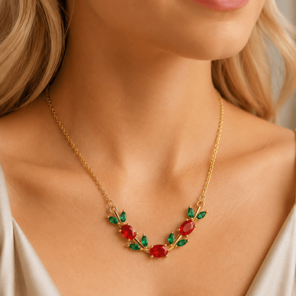 Model wearing a red and green floral leaf crystal-style necklace