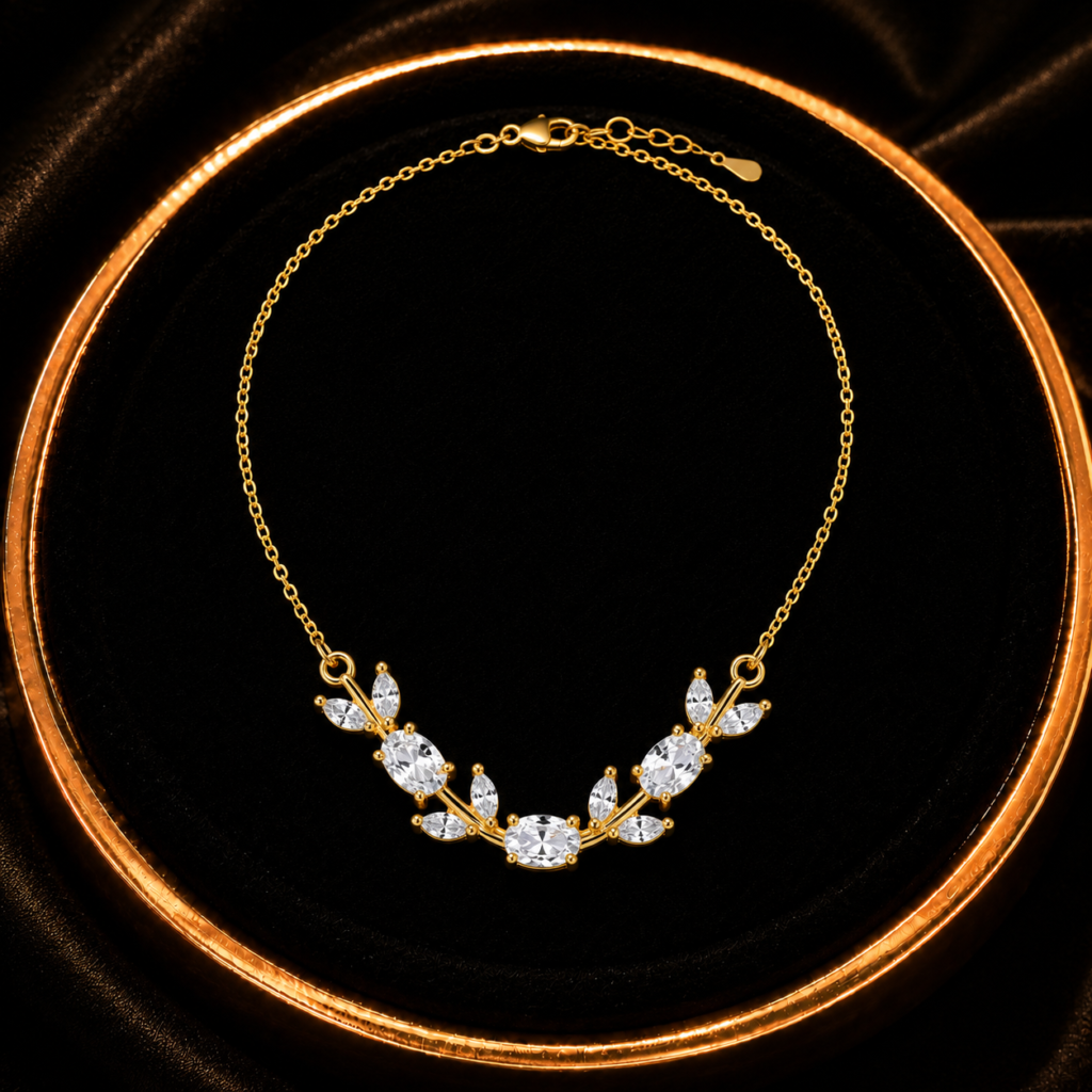 White and clear leaf crystal-style necklace displayed on a black tray