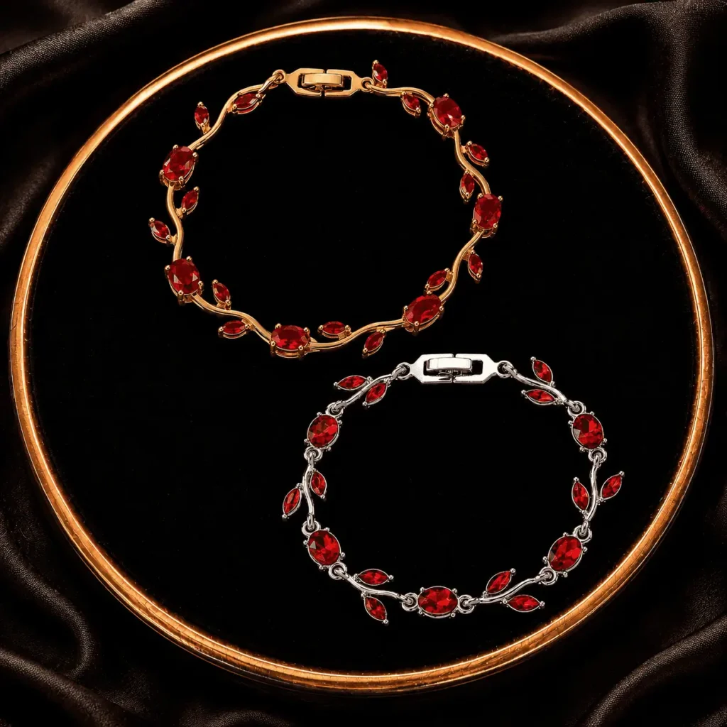 Two red and pink leaf crystal-style bracelets displayed on a black tray