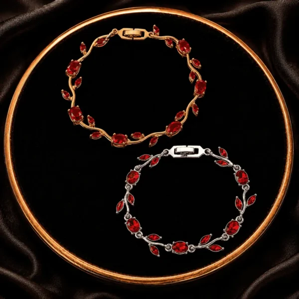 Two red and pink leaf crystal-style bracelets displayed on a black tray