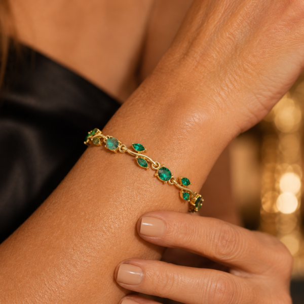 Close-up of a green leaf crystal-style bracelet worn on the wrist