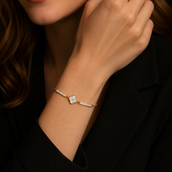 Close-up of a silver-tone bow bracelet worn on the wrist