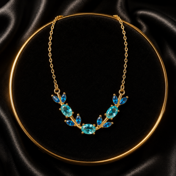 Blue butterfly and leaf crystal-style necklace arranged on black fabric