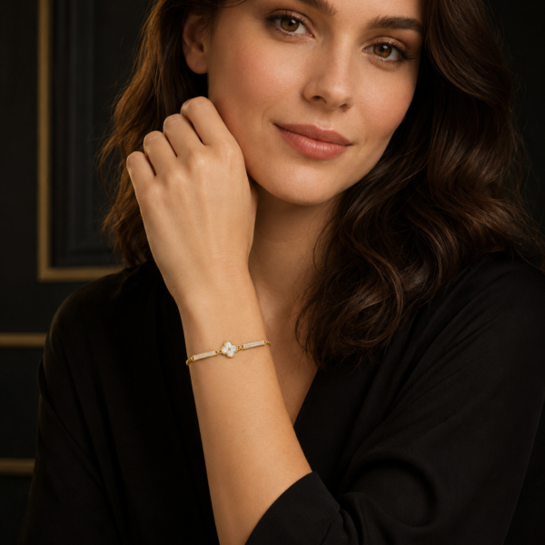 Model wearing a delicate silver-tone bow bracelet