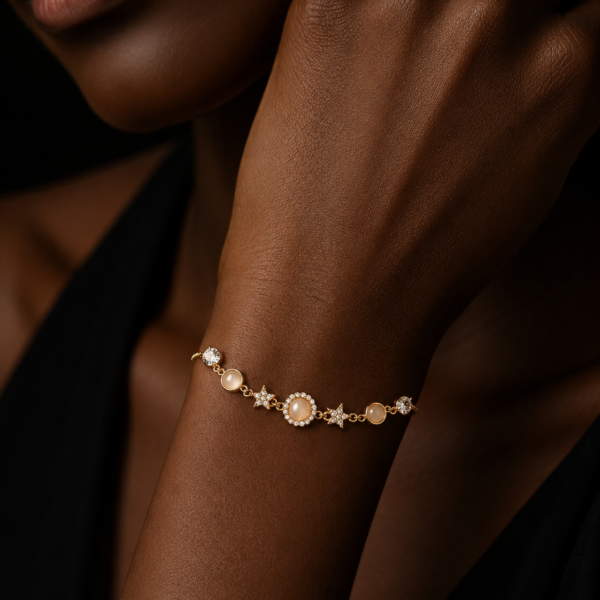 Silver-tone star and flower station bracelet worn on a dark-skinned arm