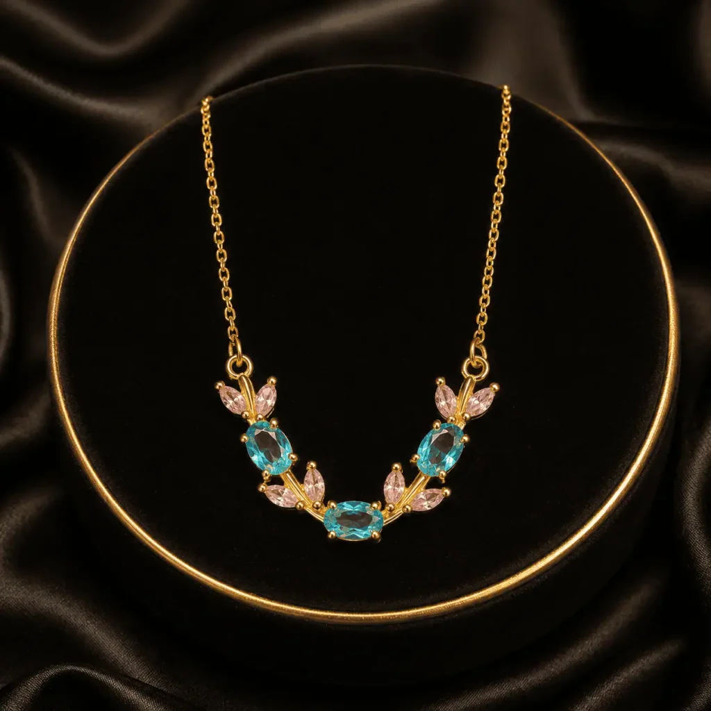 Multicolor butterfly and leaf crystal-style necklace arranged on black fabric