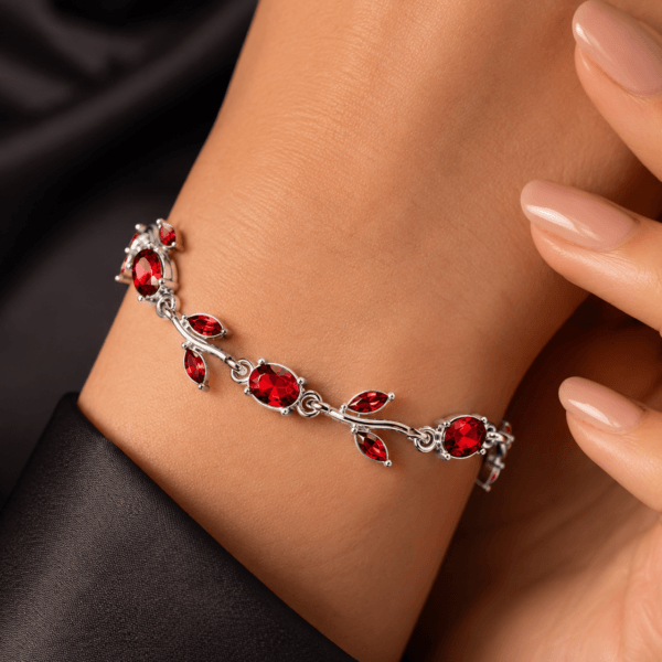 Close-up of a red leaf crystal-style bracelet worn on the wrist
