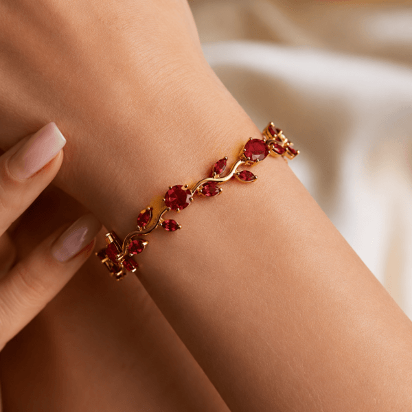 Close-up of a red leaf crystal-style bracelet worn on the wrist