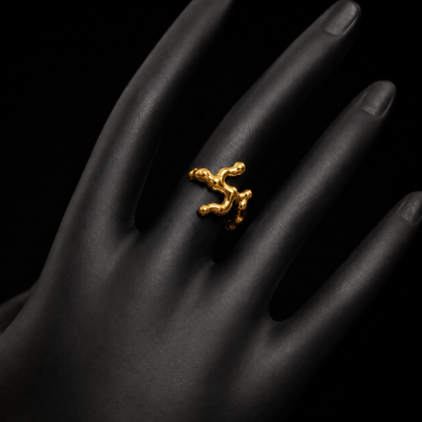 Gold-tone abstract branch open ring worn on a black mannequin hand