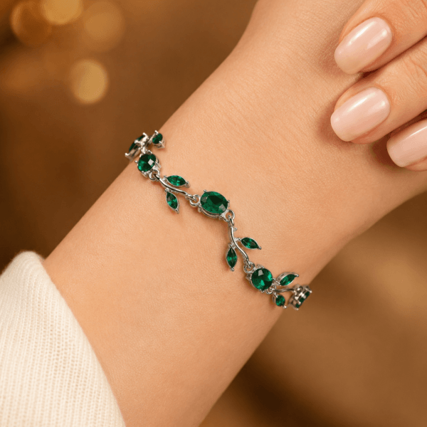 Close-up of a green leaf crystal-style bracelet worn on the wrist