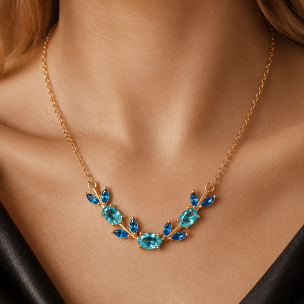 Model wearing a blue butterfly and leaf crystal-style necklace
