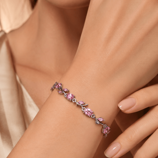 Close-up of a purple leaf crystal-style bracelet worn on the wrist